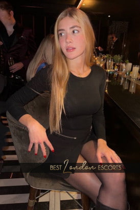 Sexy young blonde sitting at a bar