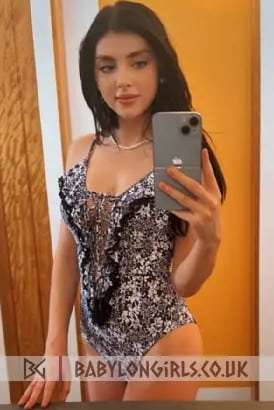 Sexy young Italian girl taking a selfie in a mirror